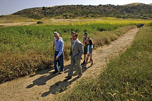Donald Bren, chairman of the Irvine Co., left, leads Gov. Arnold Schwarzenegger and others through Bommer Canyon, part of a nearly 40,000-acre swath of Orange County open space that has been designated as the first California Natural Landmark.