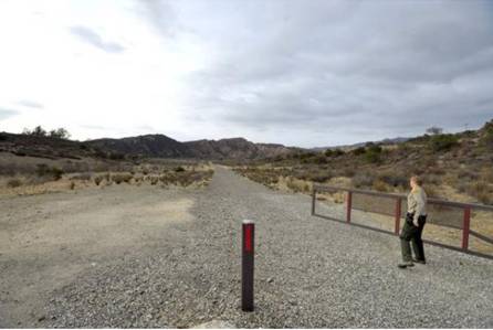 John Gump, operations manager of the Irvine Ranch Open Space, opens a gate on Red Rock Ridge Road in Black Star Canyon. The area was part of a 2010 land gift from the Irvine Company.