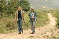 DOUGLAS ZIMMERMAN / DAILY PILOT Irvine Company Chairman Donald Bren walks Thursday with U.S. Secretary of Interior Gale Norton on an Irvine Regional Park trail.