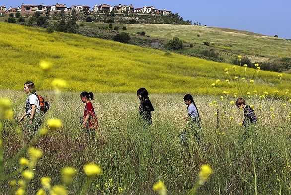 Children from Bonita Canyon Elementary School in Irvine walk through Bommer Canyon to attend the announcement ceremony — timed to coincide with Earth Day — designating the historic Irvine Ranch land as the first California Natural Landmark. To make the statewide list, land must be mostly undisturbed and have such biological and geological significance that it could have been preserved as a state or national park.